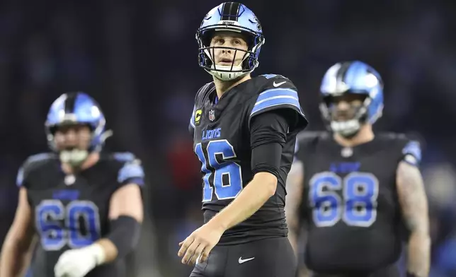 Detroit Lions quarterback Jared Goff (16) reacts on the field in front of guard Graham Glasgow (60) and offensive tackle Taylor Decker (68) during the second half of an NFL football game against the Buffalo Bills, Sunday, Dec. 15, 2024, in Detroit. (AP Photo/Rey Del Rio)