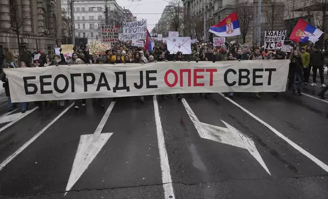 Students carry banner reading: "Belgrade is the World again" during a protest protest that erupted after a concrete canopy fell last month and killed 15 people in Belgrade, Serbia, Wednesday, Dec. 25, 2024. (AP Photo/Darko Vojinovic)