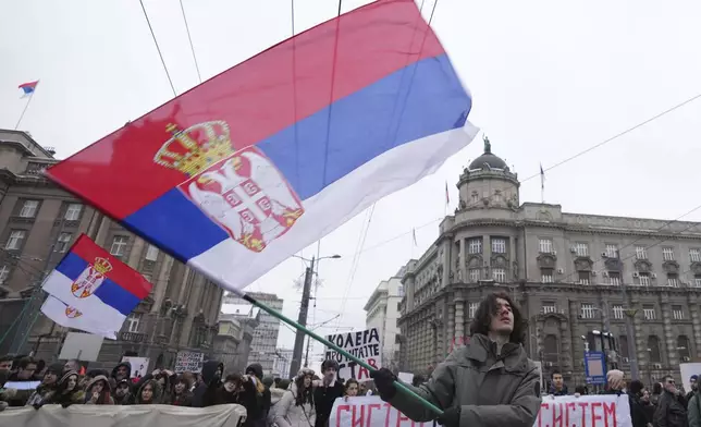 Students march during a protest protest that erupted after a concrete canopy fell last month and killed 15 people in Belgrade, Serbia, Wednesday, Dec. 25, 2024. (AP Photo/Darko Vojinovic)