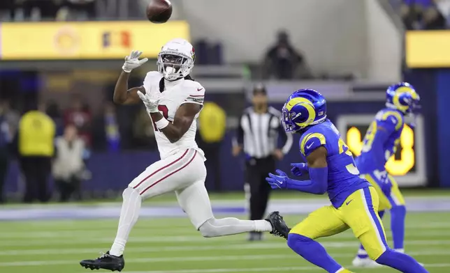 Arizona Cardinals wide receiver Marvin Harrison Jr., left, makes a catch past Los Angeles Rams safety Quentin Lake, right, during the second half of an NFL football game Saturday, Dec. 28, 2024, in Inglewood, Calif. (AP Photo/Ryan Sun)