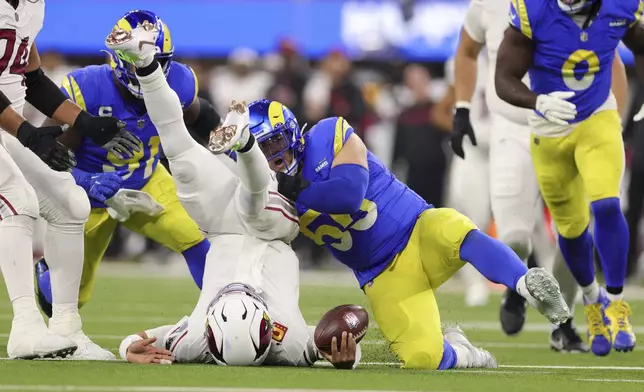 Arizona Cardinals quarterback Kyler Murray, left, is sacked by Los Angeles Rams defensive tackle Braden Fiske (55) during the first half of an NFL football game Saturday, Dec. 28, 2024, in Inglewood, Calif. (AP Photo/Ryan Sun)