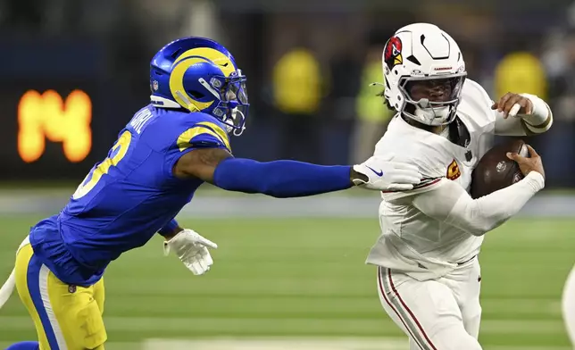 Arizona Cardinals quarterback Kyler Murray (1) runs past Los Angeles Rams safety Kamren Curl (3) during the first half of an NFL football game Saturday, Dec. 28, 2024, in Inglewood, Calif. (AP Photo/Alex Gallardo)