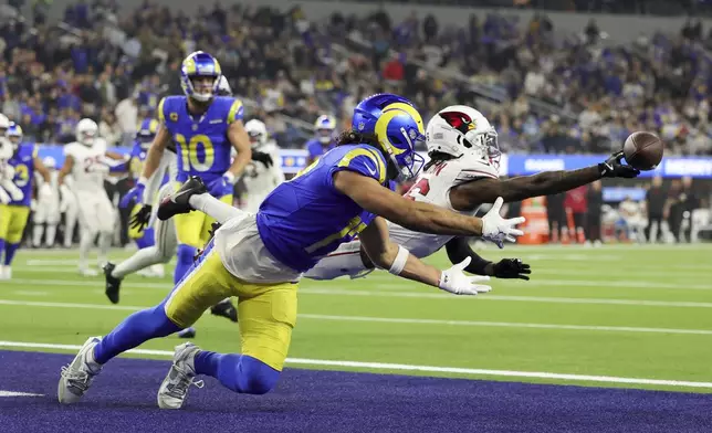 Arizona Cardinals cornerback Max Melton, right, breaks up a pass intended for Los Angeles Rams wide receiver Puka Nacua during the second half of an NFL football game Saturday, Dec. 28, 2024, in Inglewood, Calif. (AP Photo/Ryan Sun)