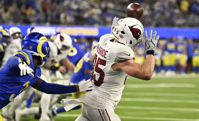 The ball deflects off Arizona Cardinals tight end Trey McBride's helmet in the closing seconds of an NFL football game against the Los Angeles Rams, Saturday, Dec. 28, 2024, in Inglewood, Calif. (AP Photo/Alex Gallardo)