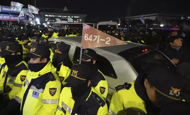 Police officers stand outside the National Assembly in Seoul, South Korea, Wednesday, Dec. 4, 2024. (AP Photo/Lee Jin-man)