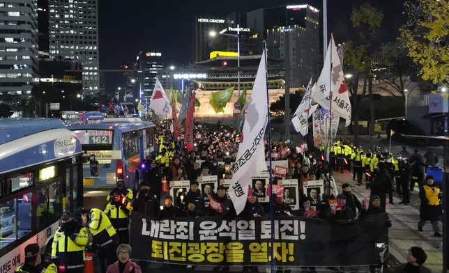 Protesters march to the presidential office after a candlelight vigil against South Korean President Yoon Suk Yeol in Seoul, South Korea, Thursday, Dec. 5, 2024. (AP Photo/Ahn Young-joon)