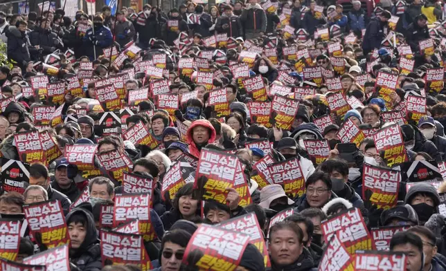 Protesters stage a rally to demand South Korean President Yoon Suk Yeol's impeachment in Seoul, South Korea, Thursday, Dec. 12, 2024. The signs read "Arrest the rebellion leader Yoon Suk Yeol." (AP Photo/Ahn Young-joon)