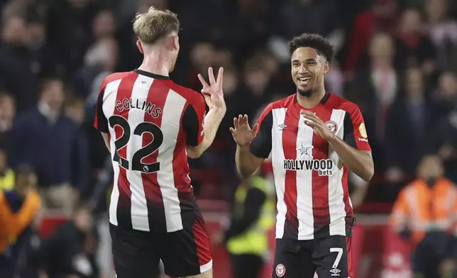 Brentford's Kevin Schade celebrates scoring his side's fourth goal of the game, during the English Premier League soccer match between Brentford and Leicester City at the Gtech Community Stadium, in Brentford, England, Saturday, Nov. 30, 2024. (Steven Paston/PA via AP)