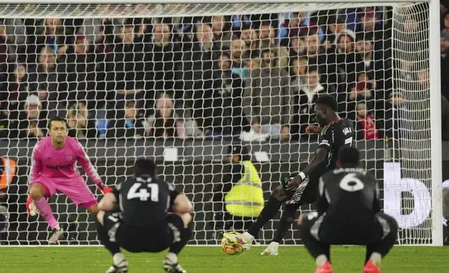 Arsenal's Bukayo Saka scores his side's fifth goal during the English Premier League soccer match between West Ham and Arsenal at the London Stadium in London, Saturday, Nov. 30, 2024. (AP Photo/Dave Shopland)