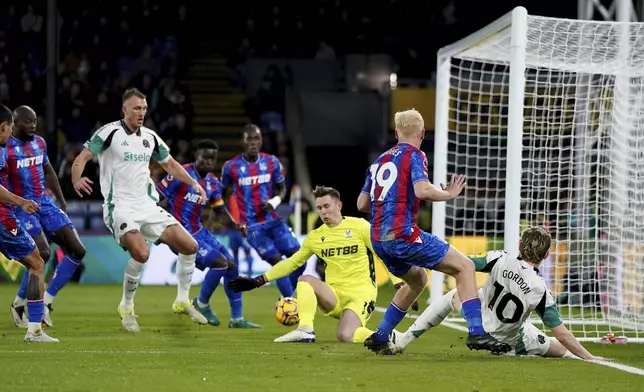 Newcastle United's Anthony Gordon (right) crosses the ball into the box resulting in an own goal by Crystal Palace's Marc Guehi during the English Premier League soccer match between Crystal Palace and Newcastle United at Selhurst Park, London, Saturday Nov. 30, 2024. (Ben Whitley/PA via AP)