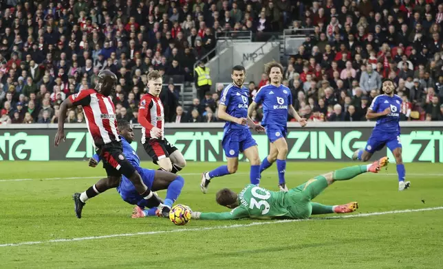 Brentford's Yoane Wissa, left, scores his side's first goal of the game, during the English Premier League soccer match between Brentford and Leicester City at the Gtech Community Stadium, in Brentford, England, Saturday, Nov. 30, 2024. (Steven Paston/PA via AP)