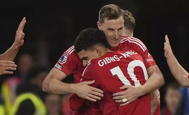 Nottingham Forest's Chris Wood, facing, celebrates scoring with teammate Morgan Gibbs-White during the English Premier League soccer match between Nottingham Forest and Ipswich Town at City Ground, Nottingham, England, Saturday Nov. 30, 2024. (Joe Giddens/PA via AP)