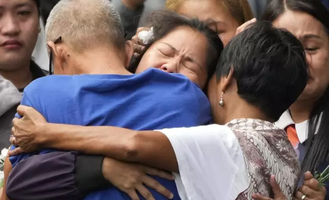 Mary Jane Veloso, center, a Filipino woman who spent almost 15 years in an Indonesian prison for drug trafficking and was nearly executed by firing squad in 2015, is reunited with her family as she arrives at the Correctional Institution for Women in Mandaluyong, Philippines Wednesday, Dec. 18, 2024. (AP Photo/Aaron Favila)