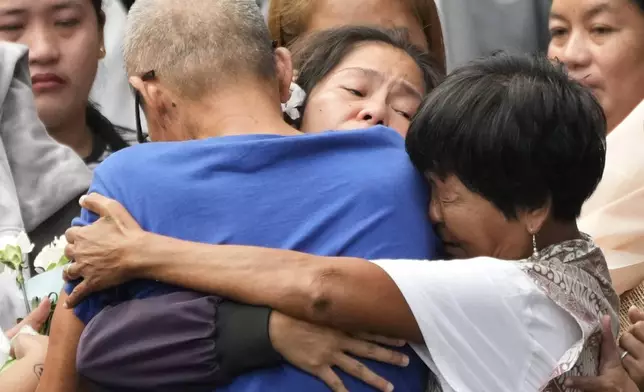 Mary Jane Veloso, center, a Filipino woman who spent almost 15 years in an Indonesian prison for drug trafficking and was nearly executed by firing squad in 2015, is reunited with her family as she arrives at the Correctional Institution for Women in Mandaluyong, Philippines Wednesday, Dec. 18, 2024. (AP Photo/Aaron Favila)