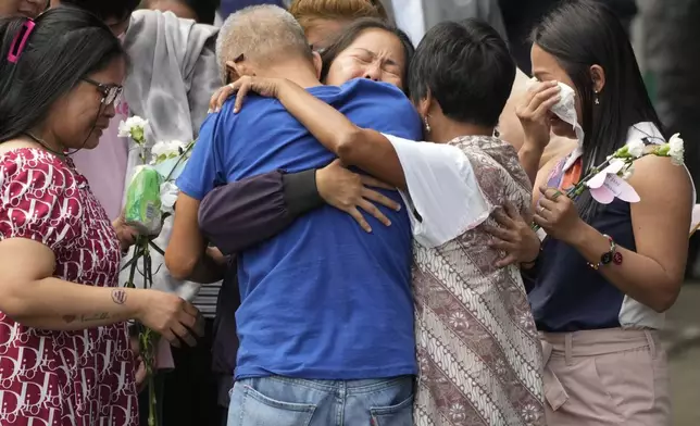 Mary Jane Veloso, center, a Filipino woman who spent almost 15 years in an Indonesian prison for drug trafficking and was nearly executed by firing squad in 2015, is reunited with her family as she arrives at the Correctional Institution for Women in Mandaluyong, Philippines Wednesday, Dec. 18, 2024. (AP Photo/Aaron Favila)