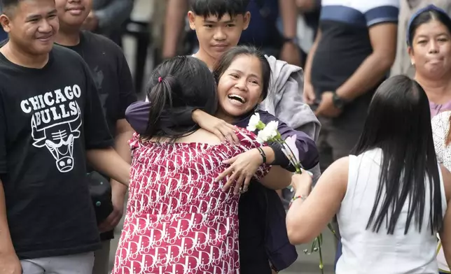 Mary Jane Veloso, center, a Filipino woman who spent almost 15 years in an Indonesian prison for drug trafficking and was nearly executed by firing squad in 2015, is reunited with her family as she arrives at the Correctional Institution for Women in Mandaluyong, Philippines Wednesday, Dec. 18, 2024. (AP Photo/Aaron Favila)