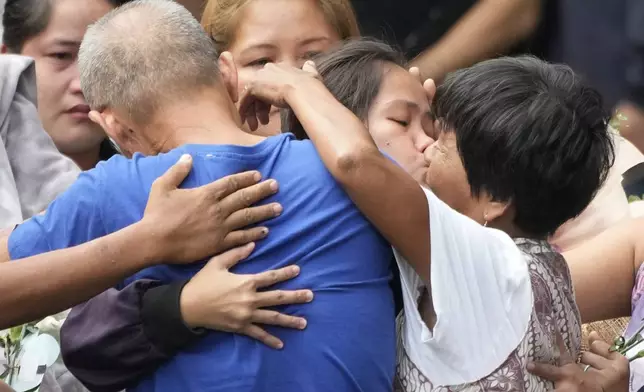 Mary Jane Veloso, center, a Filipino woman who spent almost 15 years in an Indonesian prison for drug trafficking and was nearly executed by firing squad in 2015, kisses her mother as she is reunited with her family at the Correctional Institution for Women in Mandaluyong, Philippines Wednesday, Dec. 18, 2024. (AP Photo/Aaron Favila)