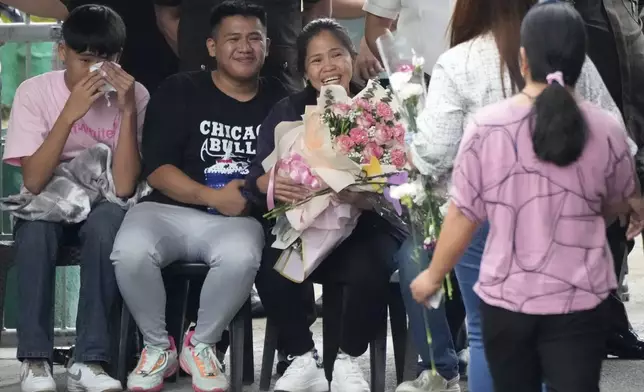 Mary Jane Veloso, center, a Filipino woman who spent almost 15 years in an Indonesian prison for drug trafficking and was nearly executed by firing squad in 2015, is reunited with her family as she arrives at the Correctional Institution for Women in Mandaluyong, Philippines Wednesday, Dec. 18, 2024. (AP Photo/Aaron Favila)