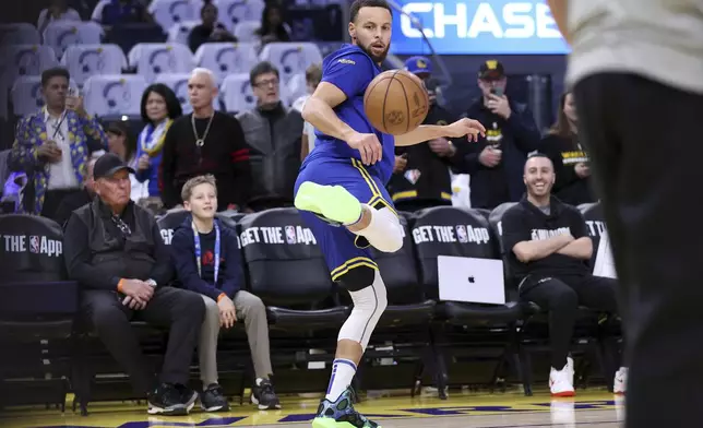 Golden State Warriors' Stephen Curry goes through his pregame warmups before playing the Los Angeles Lakers in an NBA basketball game at Chase Center in San Francisco, Wednesday, Dec. 25, 2024. (Scott Strazzante/San Francisco Chronicle via AP)