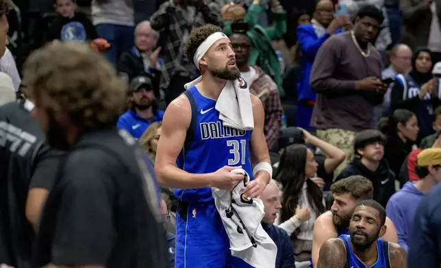 Dallas Mavericks guard Klay Thompson (31) looks on after being recognized for reaching 5th place on the all-time three-point field goals list in the second half of an NBA basketball game on Wednesday, Dec. 25, 2024, in Dallas.(AP Photo/Emil T. Lippe)