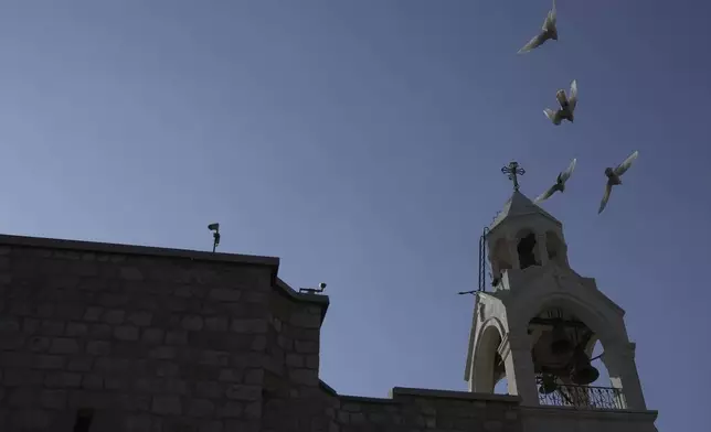 Birds fly above the Church of the Nativity, where Christians believe Jesus Christ was born, ahead of Christmas in the West Bank city of Bethlehem, Tuesday, Dec. 17, 2024. (AP Photo/Mahmoud Illean)