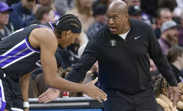 Sacramento Kings center Isaac Jones is greeted by Sacramento Kings head coach Mike Brown during the second half of an NBA basketball game against the Denver Nuggets in Sacramento, Calif., Monday, Dec. 16, 2024. The Nuggets won 130-129. (AP Photo/Randall Benton)
