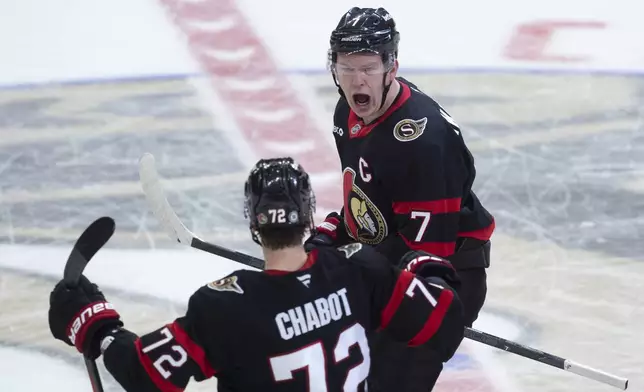 Ottawa Senators left wing Brady Tkachuk (7) celebrates after his winning goal with teammate Thomas Chabot (72) at the end of overtime NHL hockey game action against the Pittsburgh Penguins in Ottawa, Saturday, Dec. 14, 2024. (Adrian Wyld/The Canadian Press via AP)