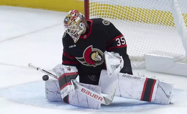 Ottawa Senators goaltender Linus Ullmark makes a save during first-period NHL hockey game action against the Pittsburgh Penguins in Ottawa, Ontario, Saturday, Dec. 14, 2024. (Adrian Wyld/The Canadian Press via AP)