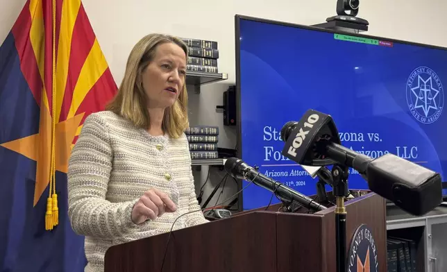 Arizona Attorney General Kris Mayes announces she's suing a Saudi Arabian company for allegedly pumping groundwater that harms local communities in a rural western county, Wednesday, Dec. 11, 2024, in Phoenix. (AP Photo/Gabriel Sandoval)