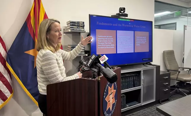 Arizona Attorney General Kris Mayes announces she's suing a Saudi Arabian company for allegedly pumping groundwater that harms local communities in a rural western county, Wednesday, Dec. 11, 2024, in Phoenix. (AP Photo/Gabriel Sandoval)