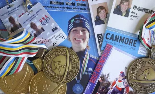 Biathlon competition medals, credentials, and media clippings belonging to Grace Boutot, silver medalist in Youth World Championships in 2009, are displayed for a photograph at her home, Oct. 17, 2024, in Boston. (AP Photo/Steven Senne)