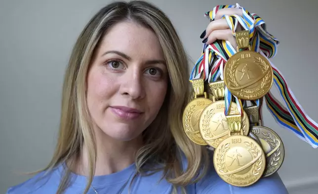 Grace Boutot, who won a silver medal in the Youth World Championships in 2009, displays a few of her medals from competitions, Oct. 17, 2024, at her home in Boston. (AP Photo/Steven Senne)