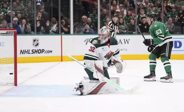 Dallas Stars right wing Evgenii Dadonov (63) scores a goal against Minnesota Wild goaltender Filip Gustavsson (32) during the first period of an NHL hockey game Friday, Dec. 27, 2024, in Dallas. (AP Photo/LM Otero)