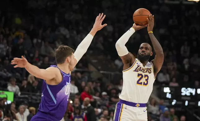 Los Angeles Lakers forward LeBron James (23) shoots the ball as Utah Jazz center Walker Kessler defends during the first half of an NBA basketball game, on Sunday, Dec. 1, 2024, in Salt Lake City. (AP Photo/Bethany Baker)