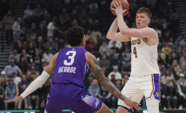 Los Angeles Lakers guard Dalton Knecht (4) looks to pass the ball as Utah Jazz guard Keyonte George (3) defends during the first half of an NBA basketball game Sunday, Dec. 1, 2024, in Salt Lake City. (AP Photo/Bethany Baker)