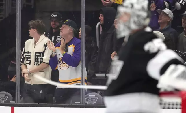 Actor Will Ferrell, second from left, celebrates after the Los Angeles Kings scored as goaltender Darcy Kuemper, right, stands in goal during the first period of an NHL hockey game Edmonton Oilers, Saturday, Dec. 28, 2024, in Los Angeles. (AP Photo/Mark J. Terrill)