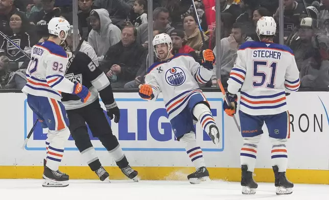 Edmonton Oilers left wing Viktor Arvidsson, second from right, celebrates his goal with right wing Vasily Podkolzin, left, and defenseman Troy Stecher during the second period of an NHL hockey game against the Los Angeles Kings, Saturday, Dec. 28, 2024, in Los Angeles. (AP Photo/Mark J. Terrill)