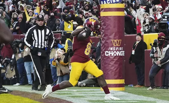 Washington Commanders wide receiver Jamison Crowder (80) scoring a touchdown against the Philadelphia Eagles during the second half of an NFL football game, Sunday, Dec. 22, 2024, in Landover, Md. (AP Photo/Stephanie Scarbrough)