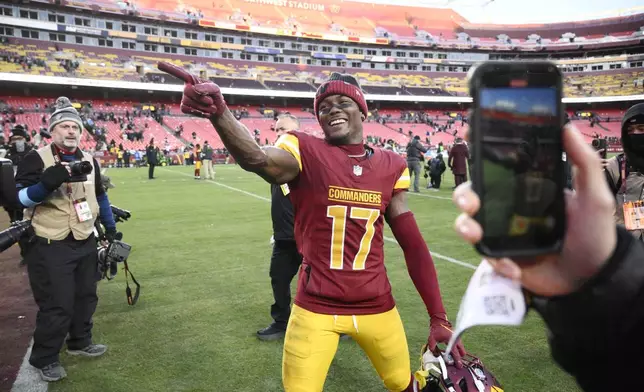 Washington Commanders wide receiver Terry McLaurin (17) gesturing to fans at the end of an NFL football game against the Philadelphia Eagles, Sunday, Dec. 22, 2024, in Landover, Md. (AP Photo/Nick Wass)