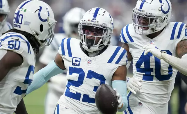 Indianapolis Colts cornerback Kenny Moore II (23) celebrates his interception with teammates Segun Olubi (50) and Jaylon Jones (40) during the first half of an NFL football game against the Tennessee Titans, Sunday, Dec. 22, 2024, in Indianapolis. (AP Photo/Darron Cummings)