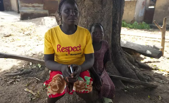 Abigail Samaniya, left, mother of Juliet Samaniya, right, 6, sit together as they speak with The Associated Press in Paseli, Nigeria, Tuesday, Nov 5, 2024. (AP Photo/Sunday Alamba)