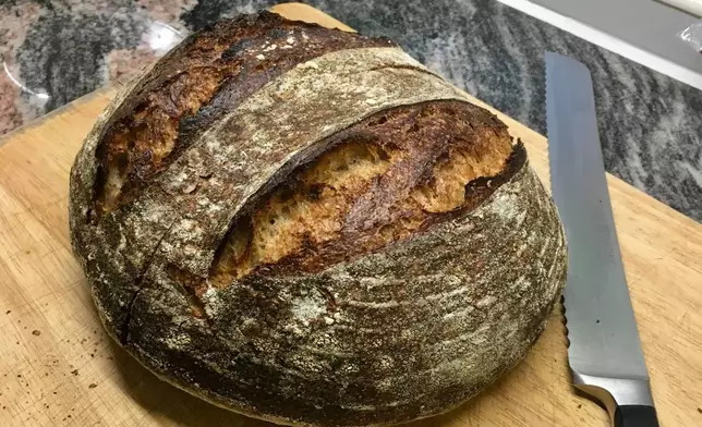 FILE - A freshly-baked loaf of sourdough bread appears at a home in London. (Matt Kemp via AP, File)