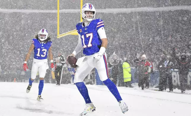 Buffalo Bills quarterback Josh Allen (17) celebrates after scoring against the San Francisco 49ers during the second half of an NFL football game in Orchard Park, N.Y., Sunday, Dec. 1, 2024. (AP Photo/Adrian Kraus)