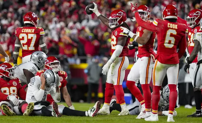 Kansas City Chiefs linebacker Nick Bolton (32) holds the recovery ball after a fumble by the Las Vegas Raiders during the second half of an NFL football game in Kansas City, Mo., Friday, Nov. 29, 2024. (AP Photo/Ed Zurga)