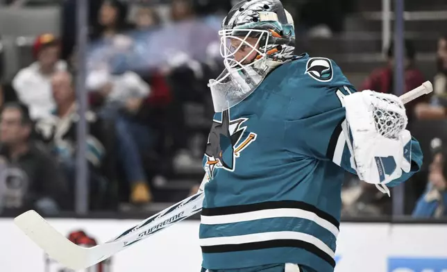 San Jose Sharks goaltender Vitek Vanecek (41) stretches during a time out against the Utah Hockey Club during the second period of an NHL hockey game Saturday, Dec. 14, 2024, in San Jose, Calif. (AP Photo/Eakin Howard)