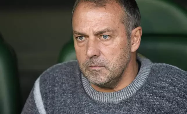 Barcelona's head coach Hansi Flick waits for the start of the Spanish La Liga soccer match between Betis and Barcelona at the Benito Villamarin stadium in Seville, Spain, Saturday, Dec. 7, 2024. (AP Photo/Jose Breton)