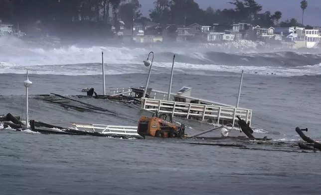 Part of a wharf and other debris floats in the ocean Monday, Dec. 23, 2024, in Santa Cruz, Calif. (Shmuel Thaler/The Santa Cruz Sentinel via AP)