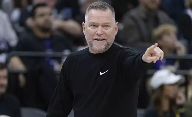 Denver Nuggets head coach Michael Malone instructs from the bench during the first half of an NBA basketball game against the Sacramento Kings in Sacramento, Calif., Monday, Dec. 16, 2024. (AP Photo/Randall Benton)