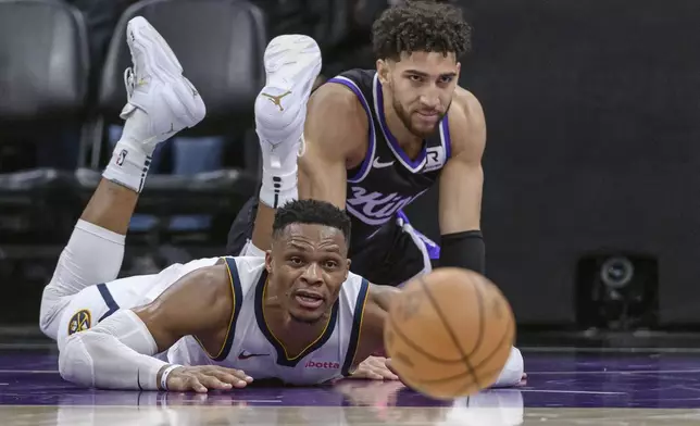 Denver Nuggets guard Russell Westbrook, left, and Sacramento Kings guard Colby Jones chase the ball during the second half of an NBA basketball game in Sacramento, Calif., Monday, Dec. 16, 2024. The Nuggets won 130-129. (AP Photo/Randall Benton)