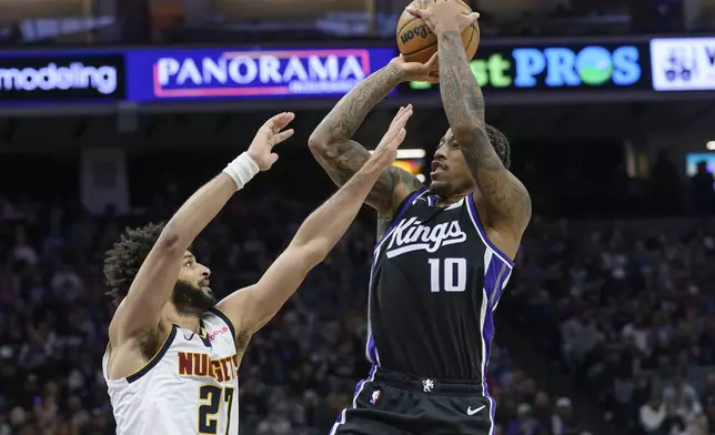Sacramento Kings forward DeMar DeRozan (10) shoots over Denver Nuggets guard Jamal Murray (27) during the second half of an NBA basketball game in Sacramento, Calif., Monday, Dec. 16, 2024. The Nuggets won 130-129. (AP Photo/Randall Benton)